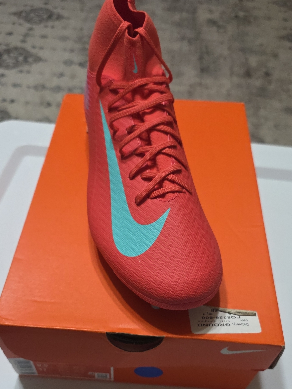Nike Men’s Coral Red Soccer Cleat with Teal Swoosh